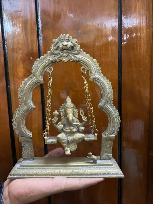 vintage brass idol of Ganesha on swing