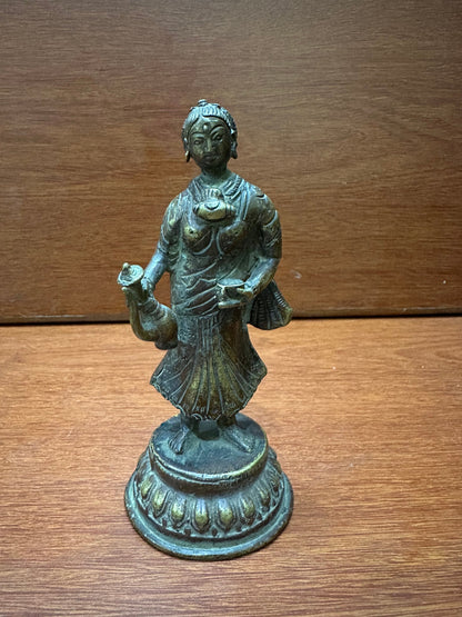 vintage bronze cast lady with surai , a wine jug serving lady