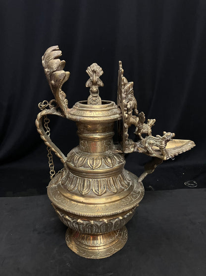 vintage brass cast north india style oil lamp with ganesha and spoon for the oil with lotus base