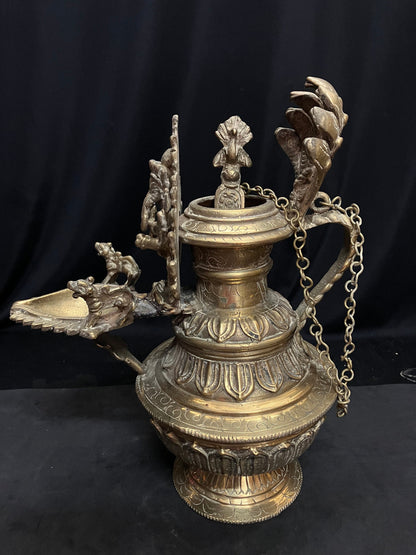 vintage brass cast north india style oil lamp with ganesha and spoon for the oil with lotus base