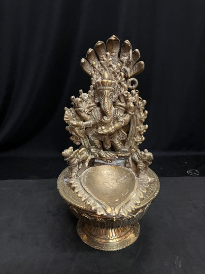 vintage brass cast north india style oil lamp with ganesha and spoon for the oil with lotus base