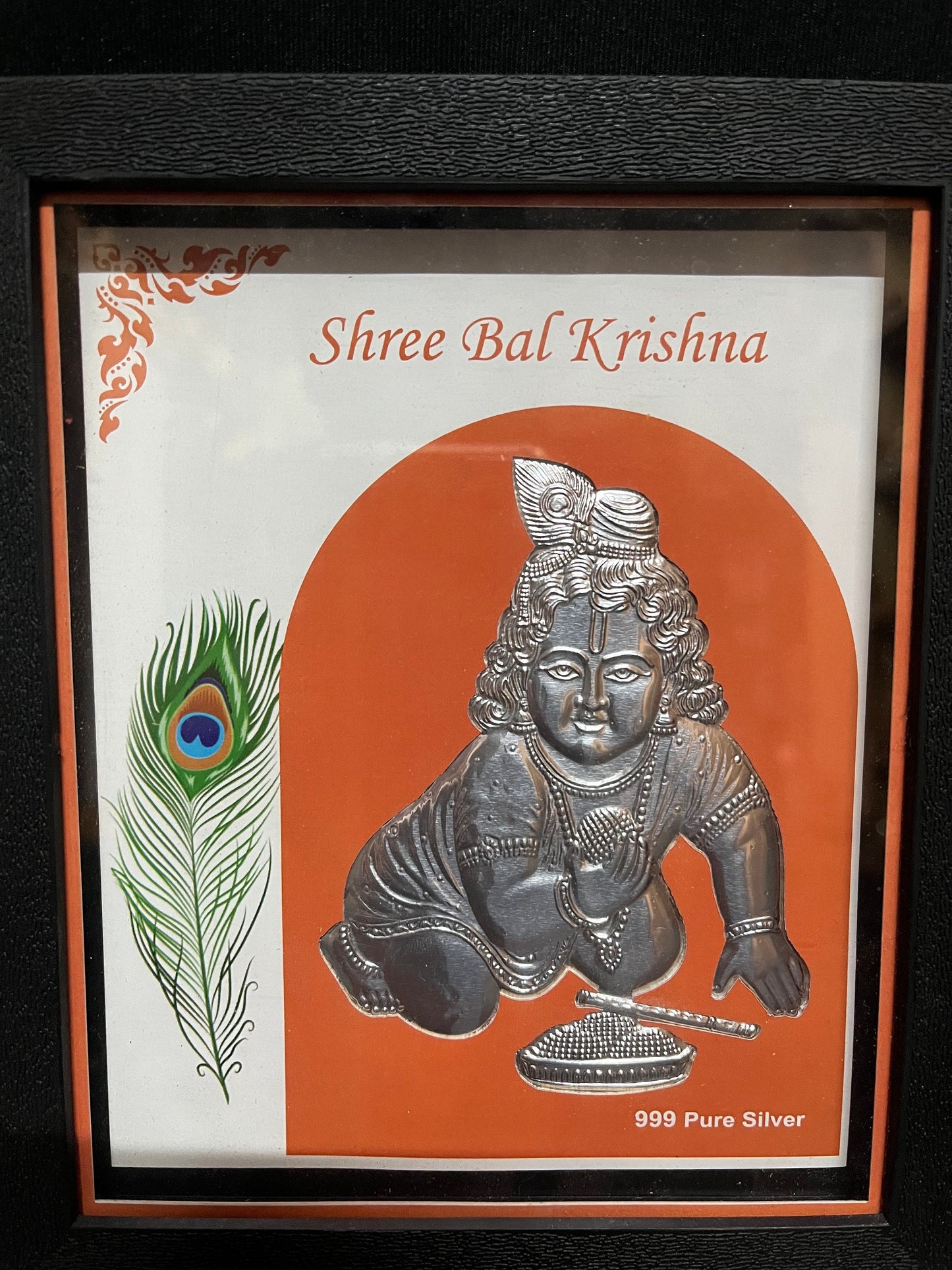 silver embossed krishna in a frame