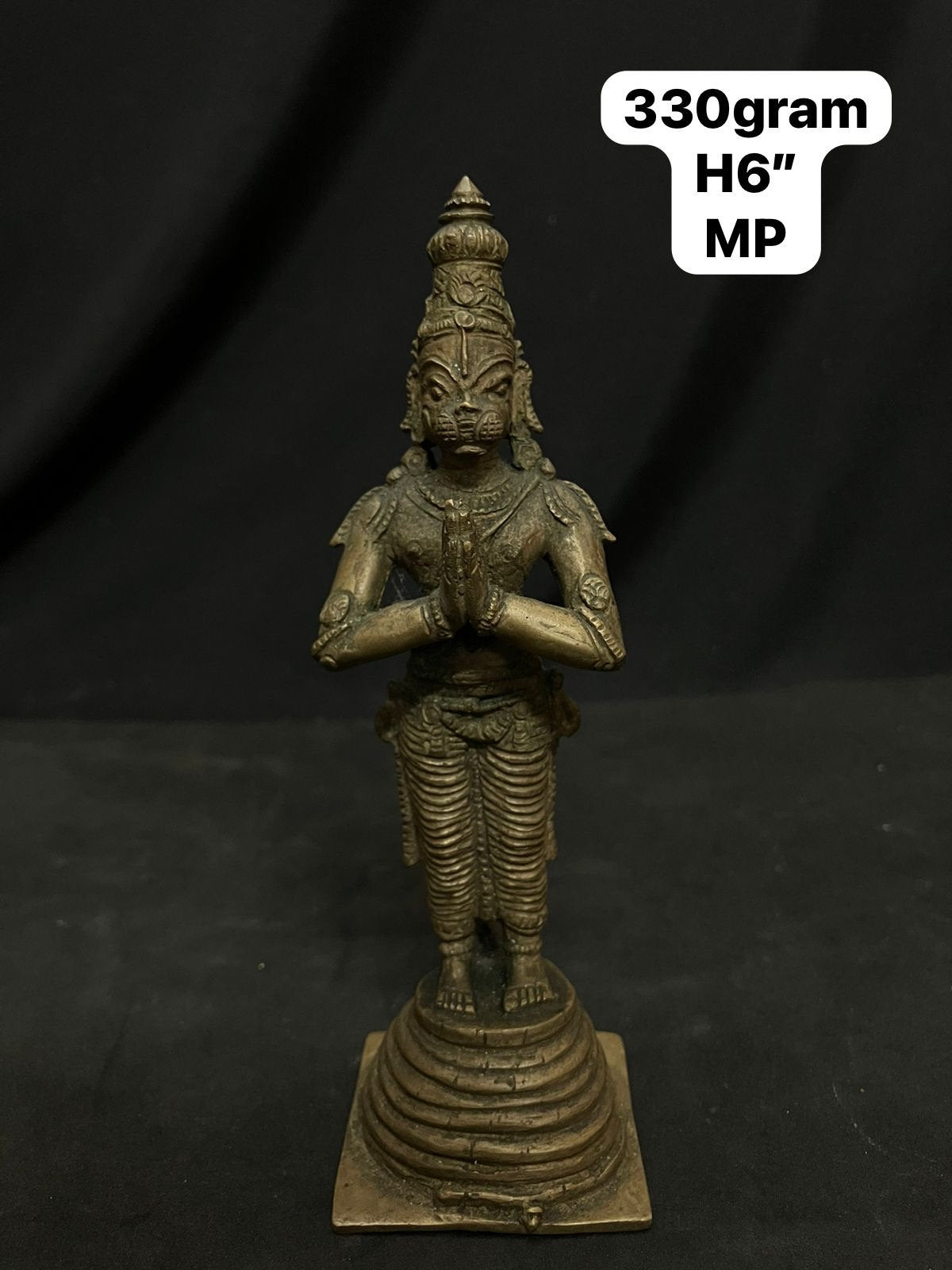 Indian antique store presents vintage idol of hanuman standing on the his tail