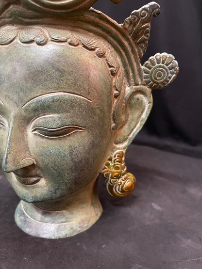 Brass cast Buddha mask with patina