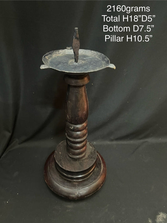 Vinatge wooden lamp with iron lamp on a wooden pillar