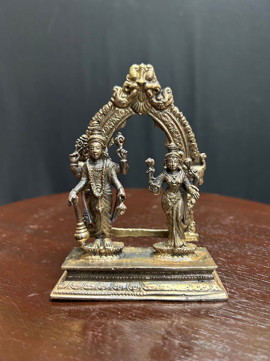 Copper made lakshmi narayana idol in a prabhavali